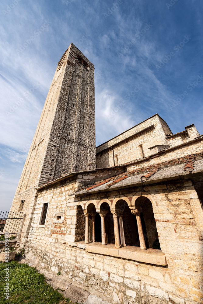Ancient Romanic parish Church of San Giorgio di Valpolicella or Ingannapoltron (VII - XI century), with the bell tower and cloister. Veneto, Verona province, Italy, Europe