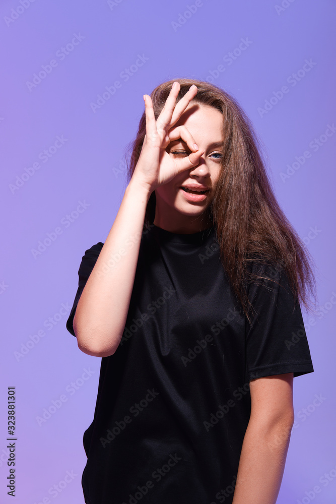 Positive funny blonde girl in casual clothes shows ok sign, laughs at camera, demonstrates that everything is fine, agrees. Positive funny blonde girl in casual clothes shows ok sign, laughs at camera, demonstrates that everything is fine, agrees.
