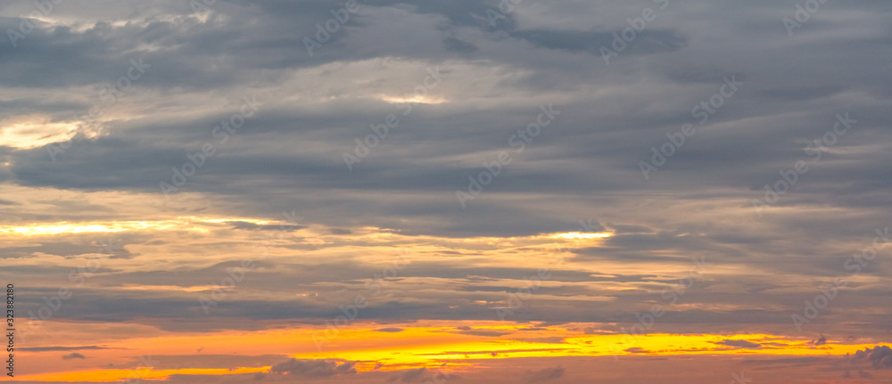 Beautiful sunrise sky. Golden, grey, and white sky. Colorful sunrise. Art picture of sky at sunrise. Sunrise and clouds for inspiration background. Nature background. Peaceful and tranquil concept.