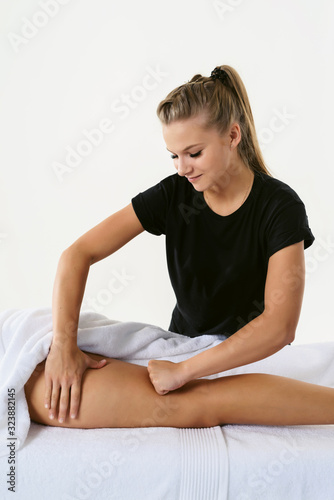 Anti cellulite massage for young woman in beauty salon. Masseur at work in beauty salon wellness center. Perfect skin fat burning beauty concept