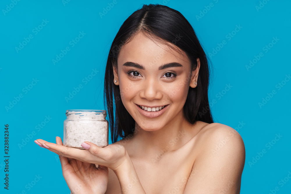 Optimistic young woman holding bath sea salt. Optimistic young woman holding bath sea salt.