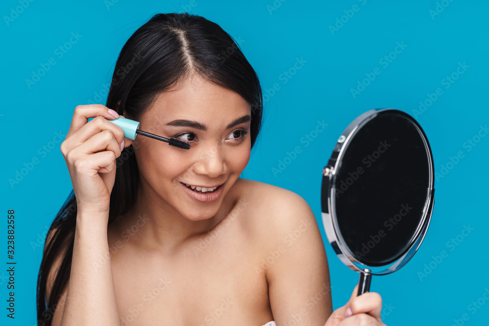 Woman posing isolated over blue wall background