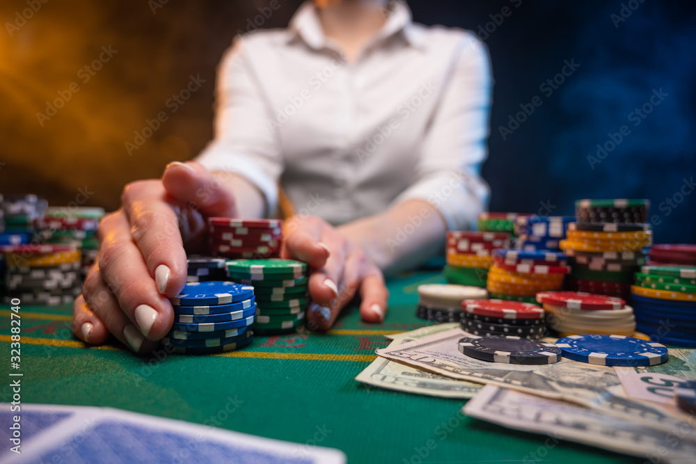 A player takes a lot of chips in a casino, .Poker game in a casino in Las Vegas. Gaming business. A player takes a lot of chips in a casino, .Poker game in a casino in Las Vegas. Gaming business.