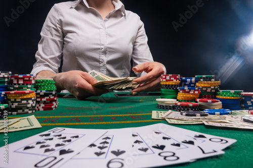 Croupier, works with cards in casinos. Poker, blackjack, money and gambling chips. Online casino, banner. photo