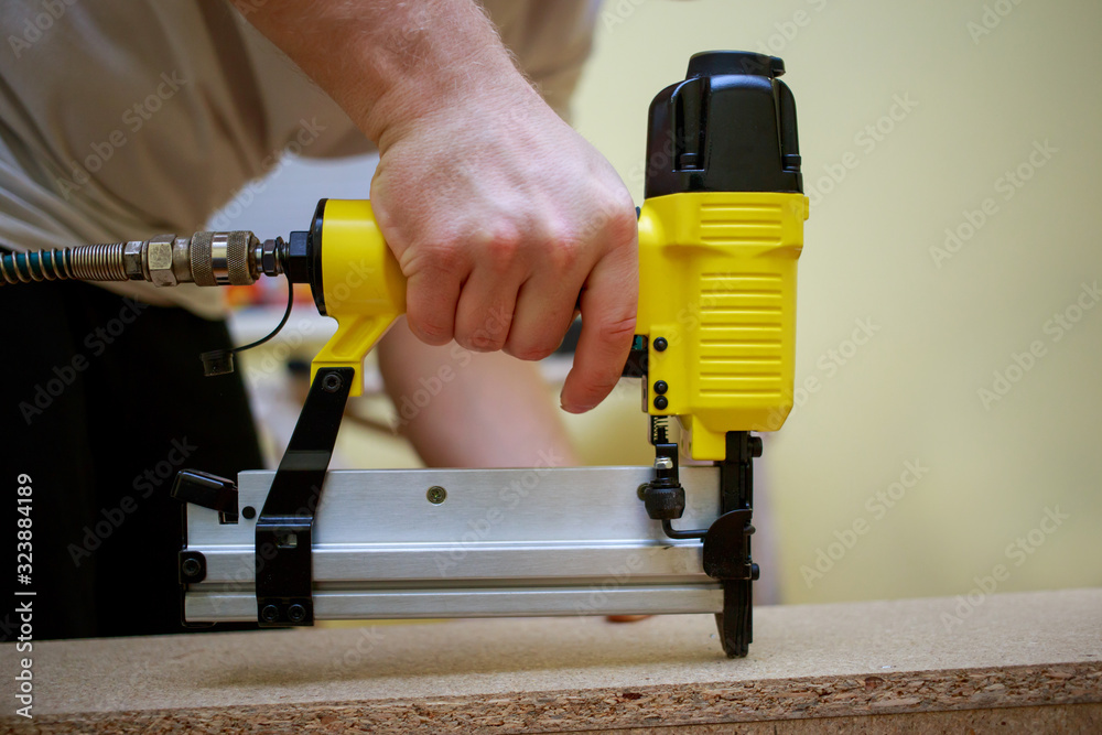 Man working with pneumatic stapler