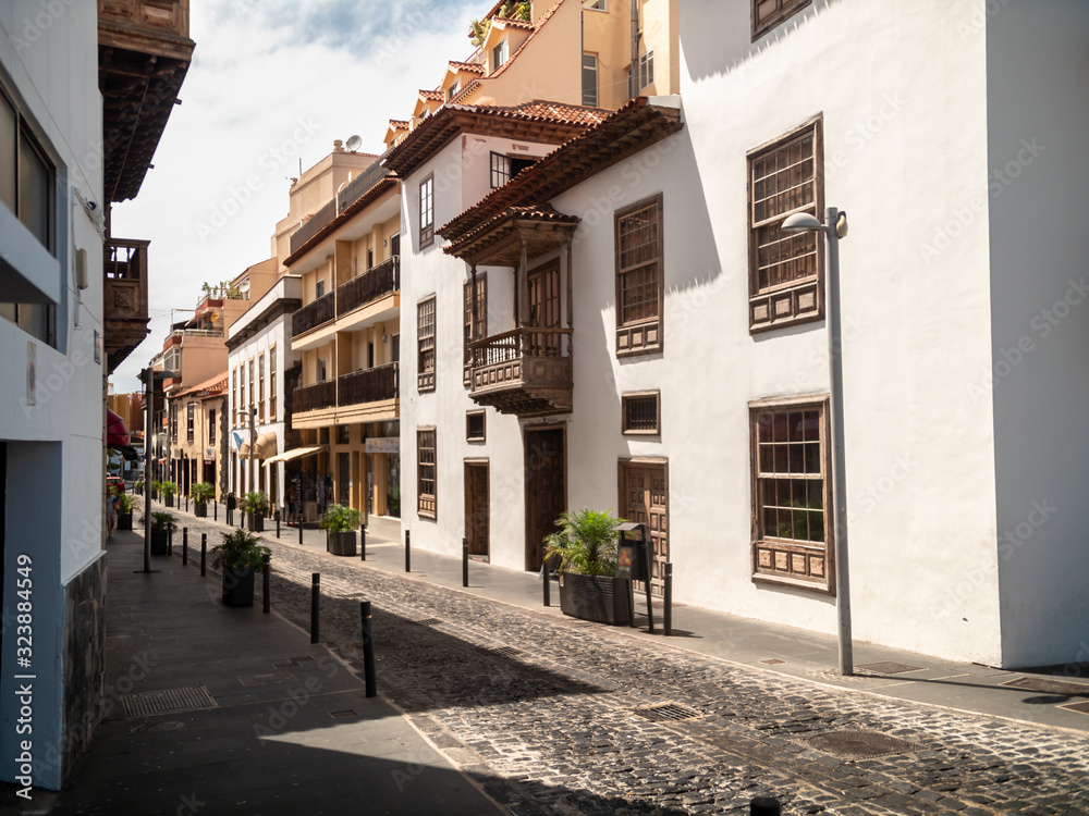 Beautiful old narrow street with cobblestone and building in colonial arhitecture style