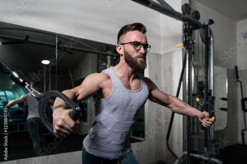 Bodybuilder Exercising Chest On Machine