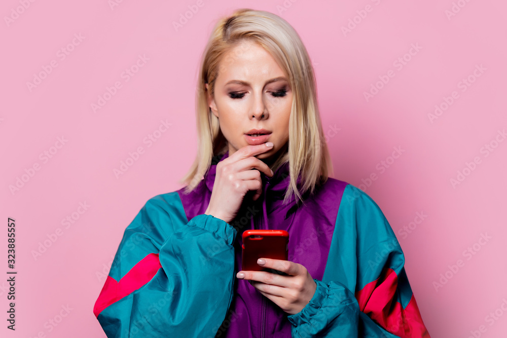 Surprised mlonde woman in sport siut of 90s on pink background Surprised mlonde woman in sport siut of 90s on pink background