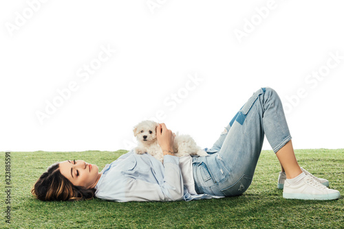 woman with Havanese puppy lying on grass isolated on white