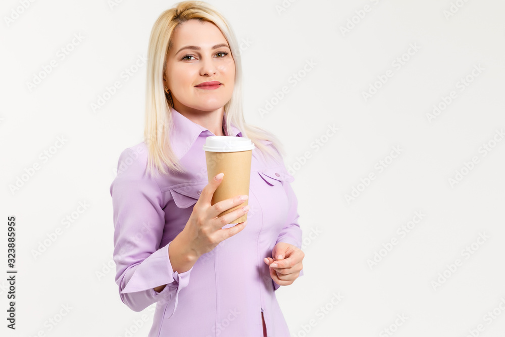 Young beautiful woman drinking paper glass of coffee over isolated white background Young beautiful woman drinking paper glass of coffee over isolated white background