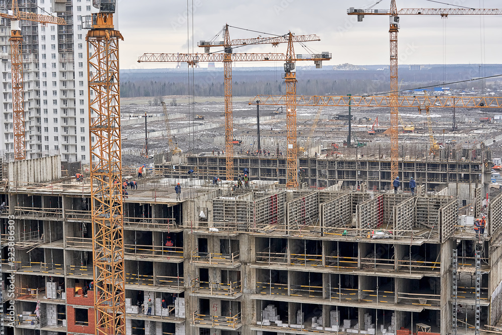 View of the construction of a residential quarter with tower cranes