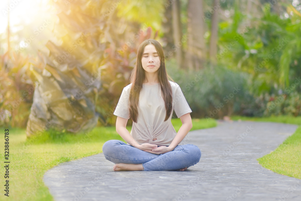 woman sitting and meditating To do yoga and exercise in the morning relax in the park woman sitting and meditating To do yoga and exercise in the morning relax in the park