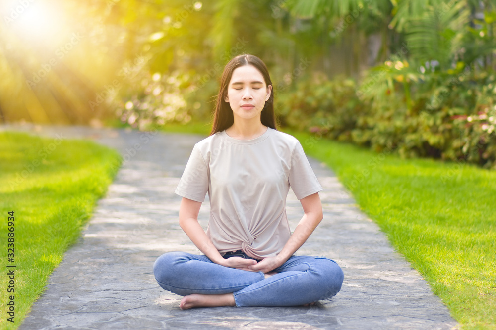 woman sitting and meditating To do yoga and exercise in the morning relax in the park woman sitting and meditating To do yoga and exercise in the morning relax in the park