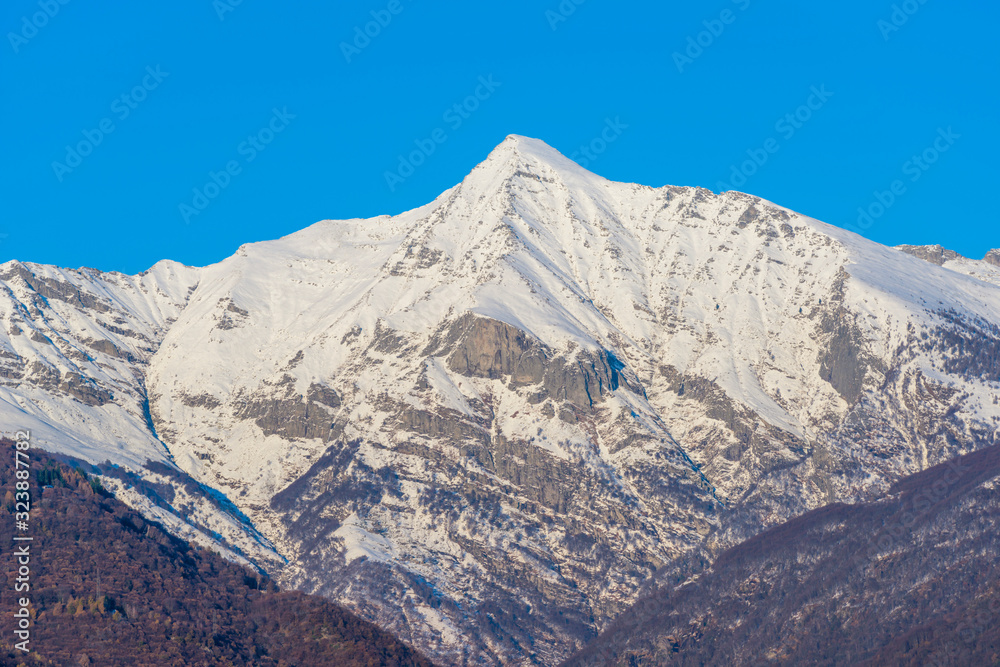 Snow-capped Mountain Peak with Clear Sky in Ticino, Switzerland.