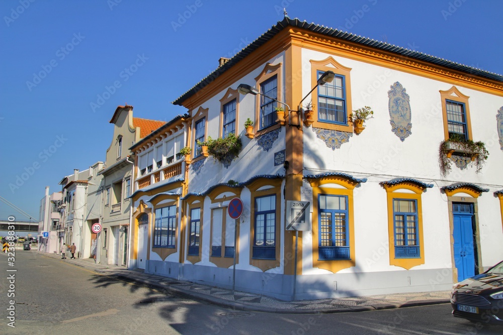 Old colorful typical facades next to the water canal in Aveiro village in Porto