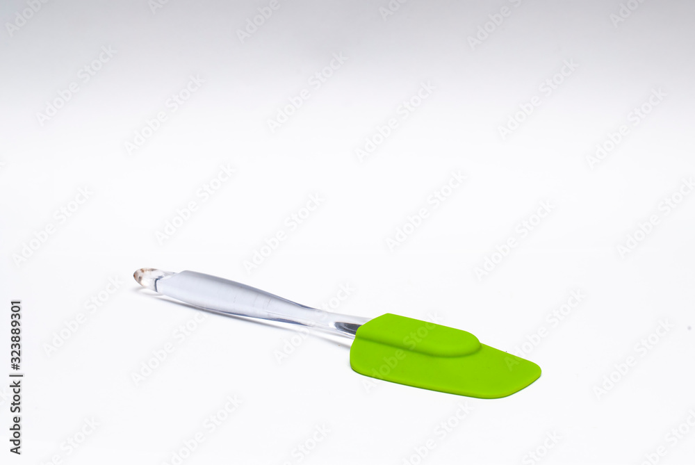 Fototapeta premium Green silicone spatula in a white background