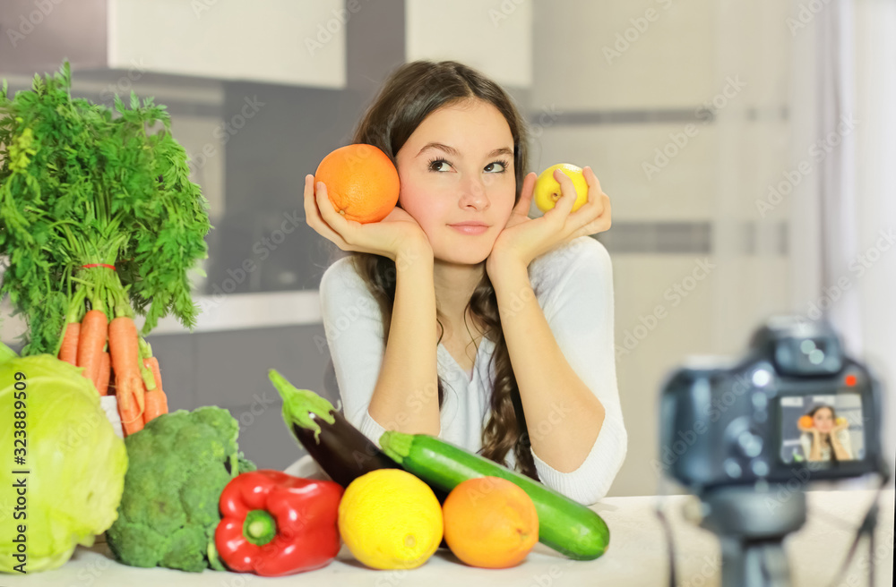 Teenage blogger explains to her followers how to eat healthy. Concept of communication among young people on the importance of healthy eating habits, vitamins and calories.