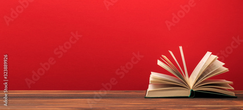 Open book  on red background. text place .