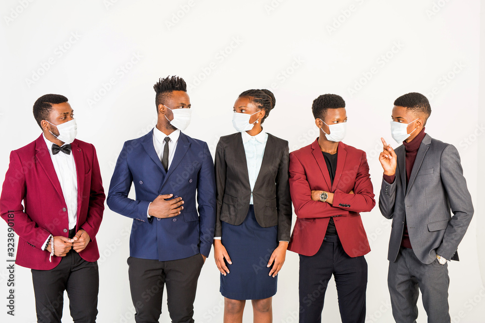 team of young handsome african men and women in suits on white background in protective masks team of young handsome african men and women in suits on white background in protective masks