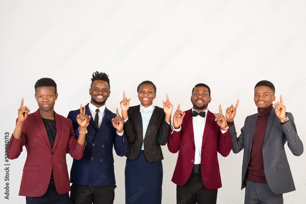 team of young handsome african men and women in suits on a white background with hand gesture team of young handsome african men and women in suits on a white background with hand gesture