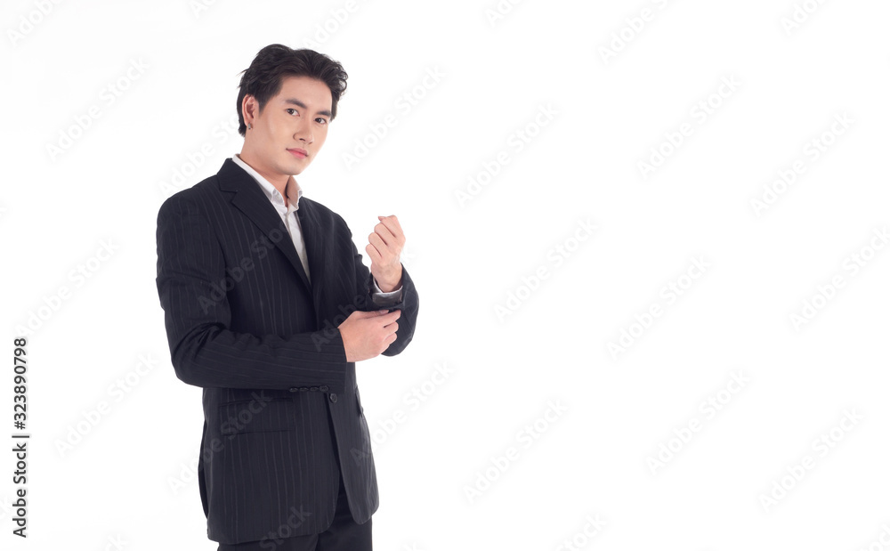 Handsome Asian business person is adjusting his cufflinks, look at the camera and smile on a white background Handsome Asian business person is adjusting his cufflinks, look at the camera and smile on a white background