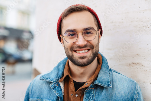 Close up of a handsome young stylish bearded man