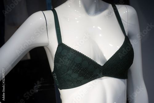 closeup of green color bra on mannequin in fashion store showroom for women