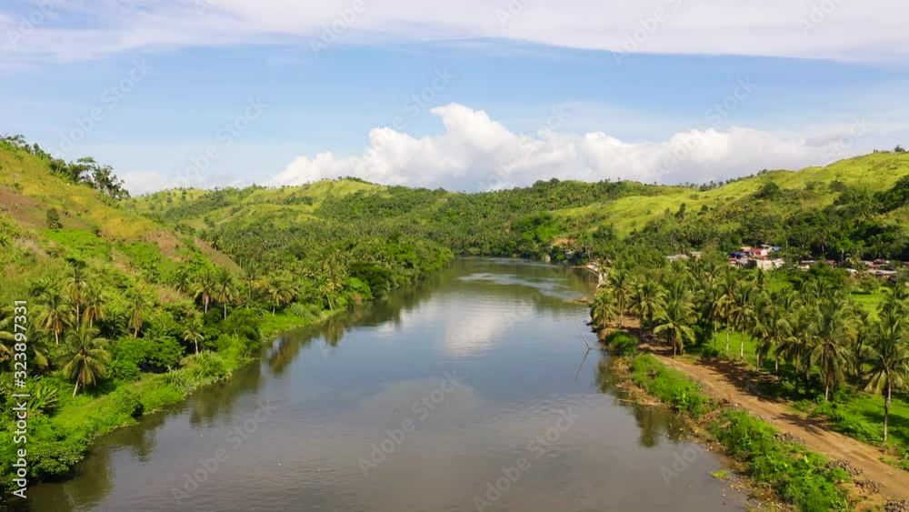 Countryside on a large tropical island. Small village on the green hills by the river. The nature of the Philippines, Samar Countryside on a large tropical island. Small village on the green hills by the river. The nature of the Philippines, Samar