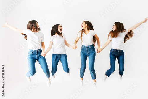 A group of girls in the studio are jumping