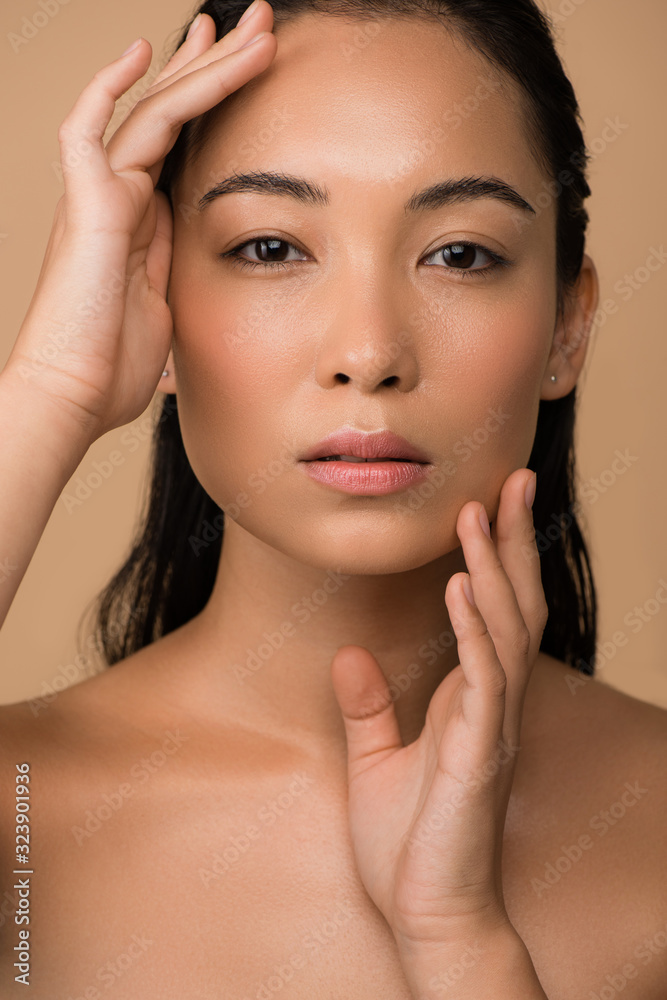 beautiful naked asian girl touching face isolated on beige beautiful naked asian girl touching face isolated on beige