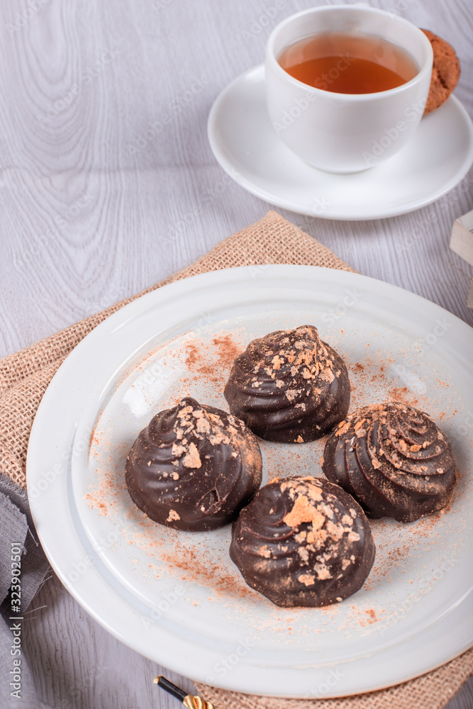 chocolate and cup of tea on the table chocolate and cup of tea on the table