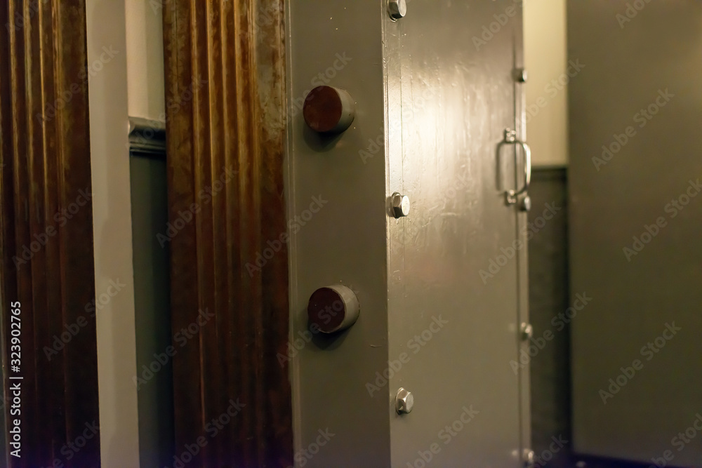 Opened old-fashioned solid vault door of a bank. Opened old-fashioned solid vault door of a bank.