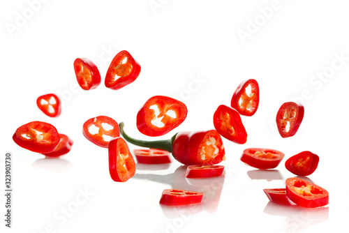 Chili pepper and its slices close-up falling