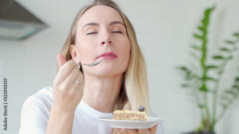 Young beautiful woman with a cake. Closeup portrait. Sitting at her home Young beautiful woman with a cake. Closeup portrait. Sitting at her home