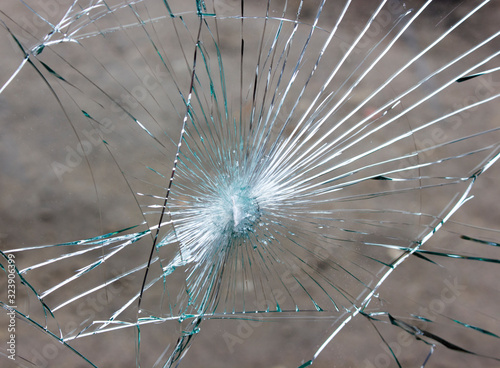 Broken car windshield, cracks in glass due to accident.