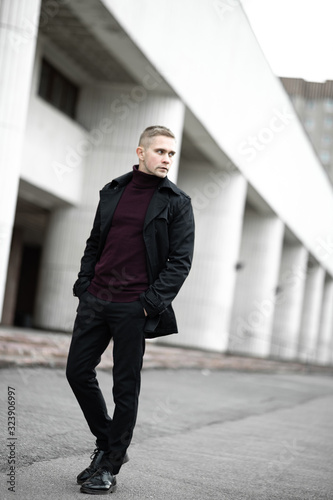 Fotografia Serious man in black trenchcoat