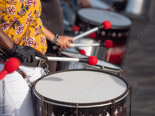 Closeup photo of group of musician playing on drums during party or carnival