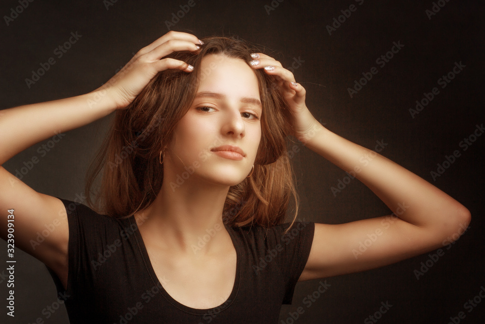 Fototapeta premium Studio portrait of a girl in a black t-shirt