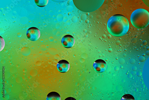 iridescent bubbles on colored green background