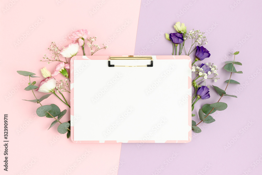 Clipboard mockup with clean white paper. Floral frame on a colorful background.