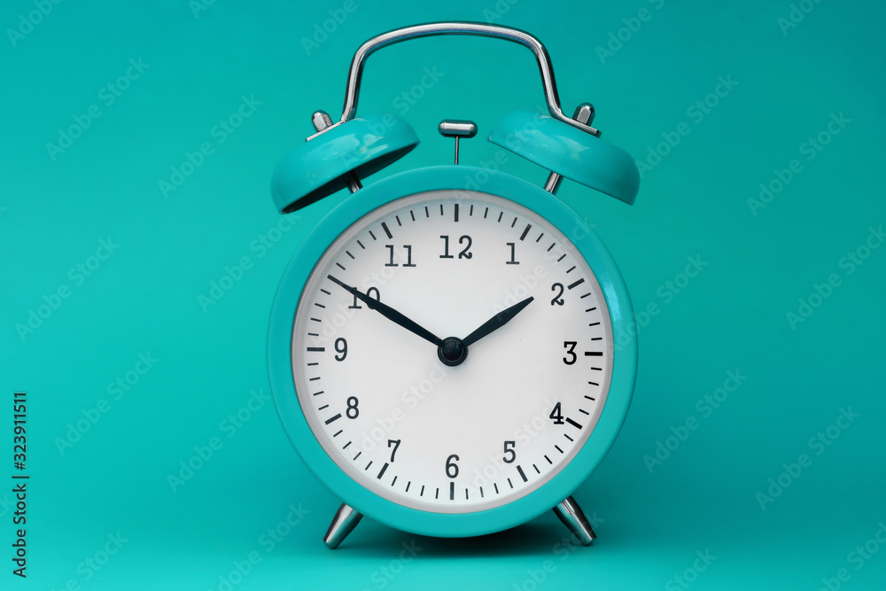 Modern alarm clock turquoise closeup object. Time online system concept - obrazy, fototapety, plakaty 