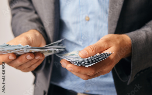a closeup of hands of a man who remits money