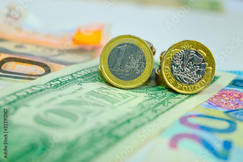 Dollar, Euro, Pound coins and banknotes