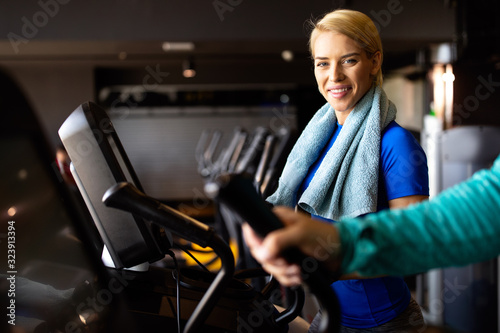 Attractive fit young woman using a step machine in the gym