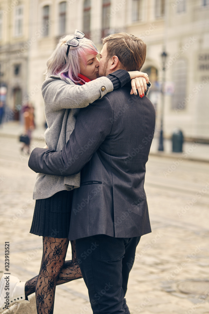 couple in love outdoor.Stunning sensual outdoor portrait of young stylish fashion couple posing in spring in city