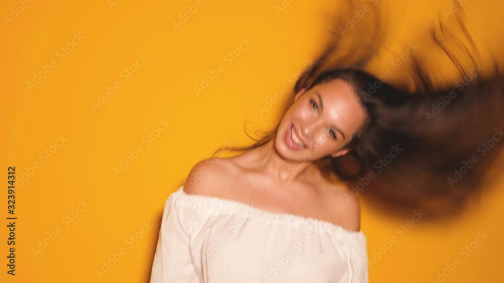 Beautiful smiling cute model shaking her head and hair Beautiful smiling cute model shaking her head and hair