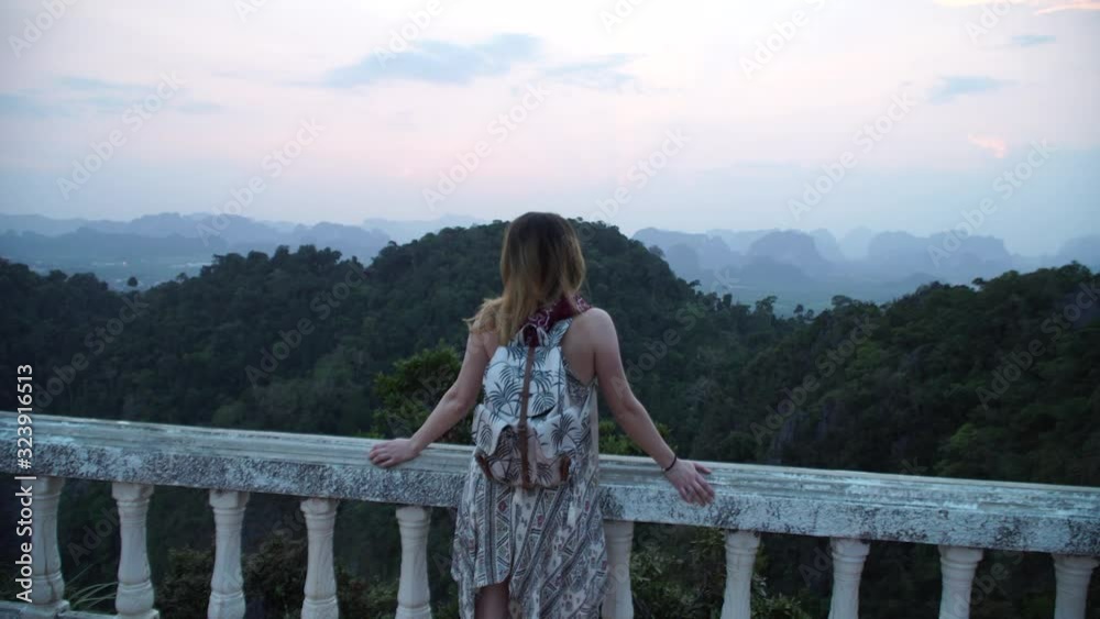 Womand enjoy's sunset on a mountain in thailand Womand enjoy's sunset on a mountain in thailand
