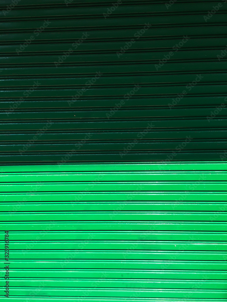 Obraz premium Corrugated metal texture or Galvanized iron steel background, shiny fence, Green Colour, Light and Shadow tone