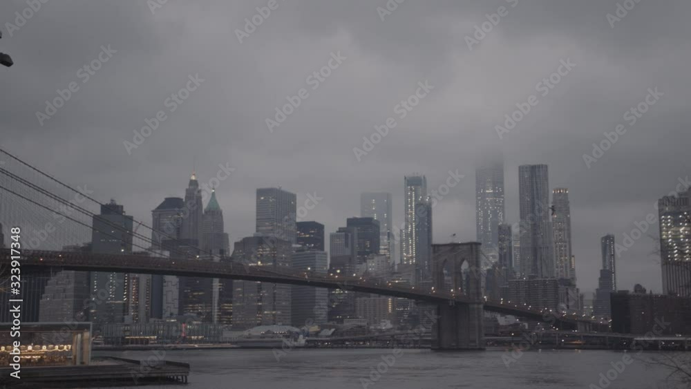 Brooklyn bridge and Manhattan skyscrapers on a fogy morning in New York City Brooklyn bridge and Manhattan skyscrapers on a fogy morning in New York City