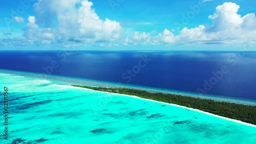 Aerial tropical seascape. Beautiful shades of blue in the calm ocean, Fulhadhoo, Maldives. photo